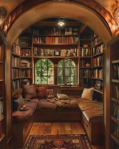 a living room filled with lots of furniture and bookshelves covered in bookcases