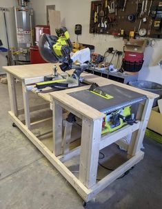 a workbench in a garage with tools on it, including a table saw