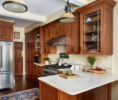 a kitchen with wooden cabinets and stainless steel appliances