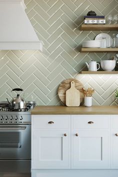 a stove top oven sitting inside of a kitchen next to a wall covered in shelves