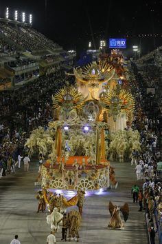 a large float in the middle of a stadium filled with people and spectators at night