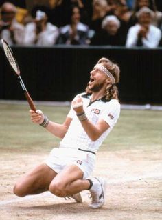 a man kneeling down holding a tennis racquet