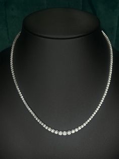 5.20 ct Round Diamond Graduated Tennis Necklace , 14k White Gold Sparkly. Condition is New with tags.    Color : F  Clarity : SI Metal : 14k white gold  Length : 17.5 inches Carat : 5.20 ct This exquisite tennis necklace showcases a breathtaking arrangement of diamonds, totaling 5.22 carats. The diamonds are meticulously set in a graduated pattern, with the largest stones positioned at the center and gradually decreasing in size towards the clasp. Each diamond is expertly cut to maximize its bri Formal Single Strand Tennis Necklace, Round Single Strand Tennis Necklace For Anniversary, Classic Round Tennis Necklace As Gift, Classic Round Tennis Necklace Gift, Classic Round Tennis Necklace For Gift, Classic Tennis Necklace Gift, Round Tennis Necklace With Prong Setting For Anniversary, Aaa Quality Round Necklaces Fine Jewelry, Aaa Quality Diamond Necklace For Anniversary