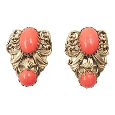 This is part of Chairish’s Costume Jewelry assortment.  1950s Baroque style goldtone cabochon faux-coral clip earrings. Marked "Napier." Measure:  1 1/2 inches by 1 1/8 inches wide.  Excellent condition. Earrings like these except with faux-turquoise cabochons are shown on pg. 322 of Melinda L. Lewis & Henry Swen's book "The Napier Co.: Defining 20th Century American Costume Jewelry."  Please reference the measurements noted in the description above for the best approximate dimensions. Please re Gold Clip-on Costume Jewelry Earrings For Parties, 1950’s Aesthetic, Orange Clip-on Earrings For Formal Occasions, 1950s Jewelry Style, Formal Orange Clip-on Earrings, Clip-on Costume Jewelry Earrings For Vintage Events, American Costume, Vintage Cabochon Clip-on Earrings, Vintage Yellow Gold Clip-on Earrings With Cabochon