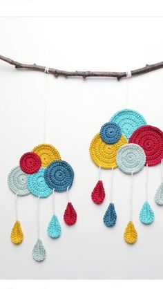 a crocheted dream catcher hanging on a twig