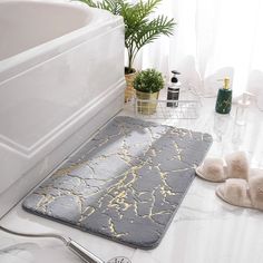 a bathroom with a bathtub and rugs on the floor