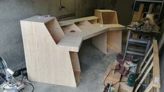 a wooden desk sitting in the middle of a garage