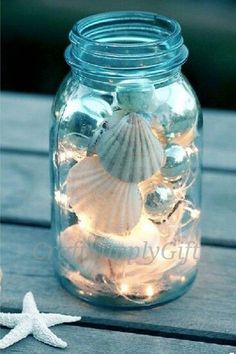 a mason jar filled with seashells and starfish