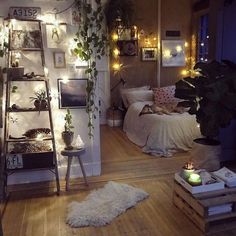 a bedroom decorated in white with plants and lights on the wall, along with a ladder