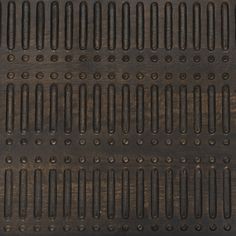 an old metal grate with holes in it's center and two rows of bars on the side