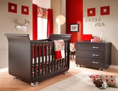 a baby's room with a crib and dresser