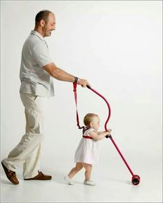 a man walking with a child on a red handle