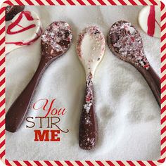 three spoons that are sitting on top of a white towel with red and white stripes