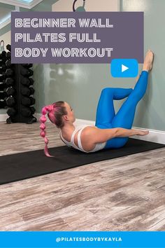 a woman in blue tights and white top doing a planker wall pilates full body workout