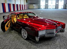 a red and black car with its door open