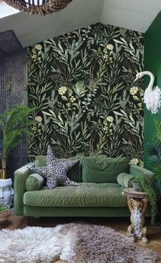 a green couch in front of a wall with plants on it and a starfish hanging from the ceiling