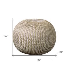 a large white ball sitting on top of a floor next to a measuring tape measure