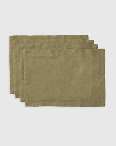 four linen placemats on a white background