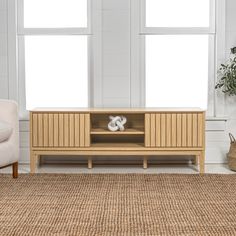 a living room scene with focus on the entertainment center and chair in the foreground