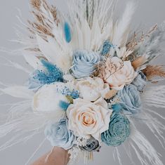 a bridal bouquet with feathers and flowers