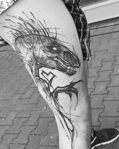 a man's leg with a drawing of a dinosaur on it and his legs