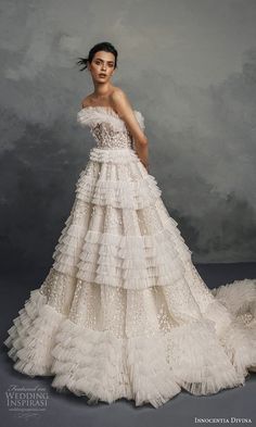 a woman in a wedding dress posing for the camera with her hands on her hips