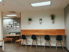 an empty room with chairs, tables and pictures on the wall above them is shown