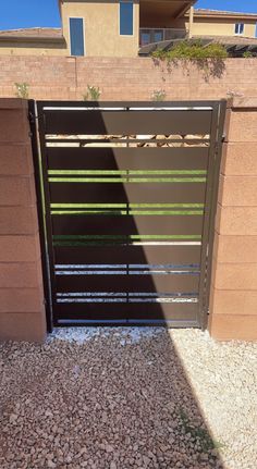 an open garage door on the side of a building with gravel in front of it