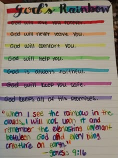 an open notebook with writing on it and rainbow written in different colors, including the words god will never leave you