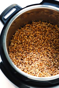 a large pot filled with brown rice on top of a table