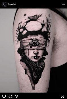 a woman's arm with a black and white tattoo design on the left shoulder