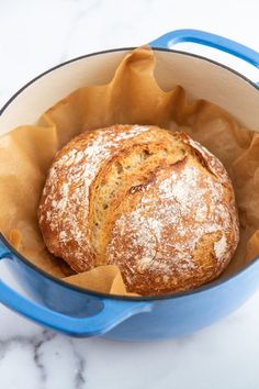 a loaf of bread sitting in a blue pot