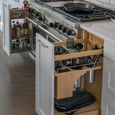 an open drawer in the middle of a kitchen