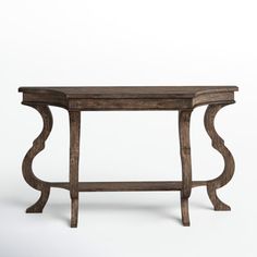 an old wooden table with curved legs and a shelf on one end, against a white background