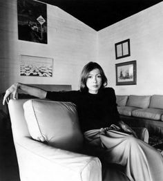 a woman sitting on top of a couch in a living room