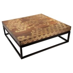 a coffee table made out of wood and metal with an intricate design on the top