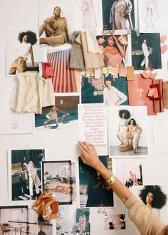 a woman's hand reaching for pictures on a wall covered in photos and photographs