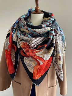 Gorgeous Imagination Coat of Armor Pattern Large Square Scarf /Shawl /Wrap Material: 70% wool 30% silk Size: 140 cm x 140 cm / 55 in x 55 in As this shawl is hand-rolled, the dimensions indicated may vary. Edges: Hand-Rolled Edges An imaginative coat of armor in hues of blue, green, and deep orange for warm and loving protection. Can style as a neck scarf, a head scarf, a shawl, or a wrap. Suitable for all seasons, gift ideas for the holiday season and special occasions Care Instructions: Please Luxury Traditional Silk Scarf For Gift, Armor Pattern, Luxury Scarf, Scarf Square, Luxury Scarves, Deep Orange, Designer Scarves, Red Coat, Scarf Gift