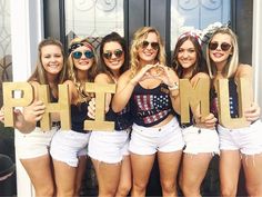 the girls are holding up letters that spell out the word h m t e s