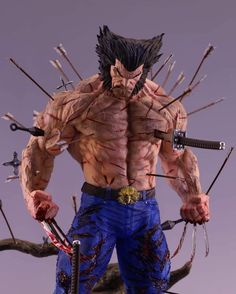 the action figure is posed in front of a gray background and has multiple swords on it