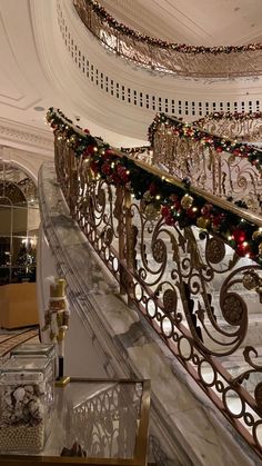 a staircase decorated for christmas with ornaments and lights