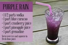 a purple drink is sitting on a wooden table with the words purple rain written below it