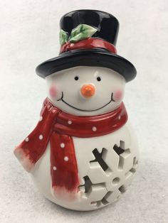 a ceramic snowman with a hat and scarf