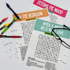 three printable word search cards on top of each other with pens and markers next to them