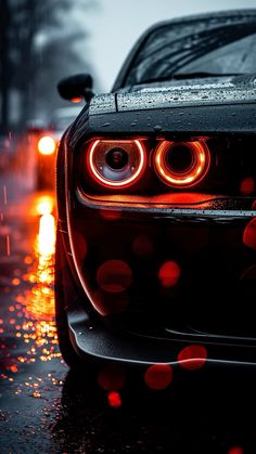 the headlights of a sports car on a wet road