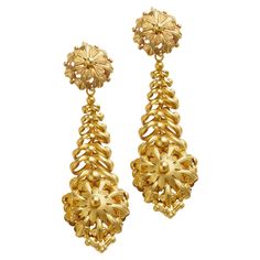 A French regional design, dating from the first half of the 19th century, these "Milanos" or "Mille Anneaux" pendant earrings are formed of 18K gold. Of hollow form, each earring is designed as a floret top suspending a highly three-dimensional reverse tapering cascade of articulated rings suspending a conforming floral sphere with scrolling foliate elements. Sculpted of light and masterfully worked in sheet gold, with delightful suppleness and flexibility, these arresting earrings are rare and uniquely beautiful. Product Details: Item #: ER-19397 Country: France Circa: First half 19th century Dimensions: 4" length x 1-1/8" width Materials: 18 karat gold Literature: A similar pair of Milanos pendant earrings are pictured in Les Bijoux des Français, Bijoux Régionaux Précieux Témoins de la V Hollow Form, Country France, Long Pendant, Pendant Earrings, French Antiques, Three Dimensional, 19th Century, Literature, 18k Gold