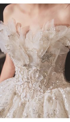 the back of a wedding dress with white flowers on it's waist and shoulders