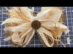 a close up of a bow made out of burlocks and lace on a cutting board