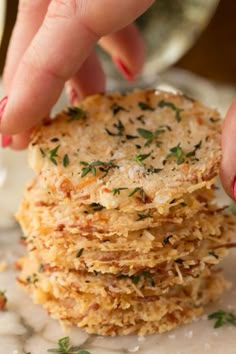 a person reaching for some food on top of a white plate