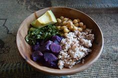 a wooden bowl filled with different types of food